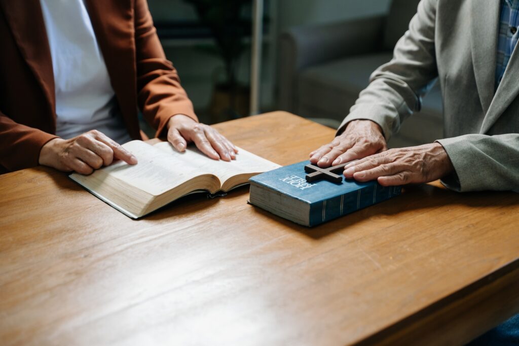 Two people reading and study bible in home and pray together.Studying the Word Of God
