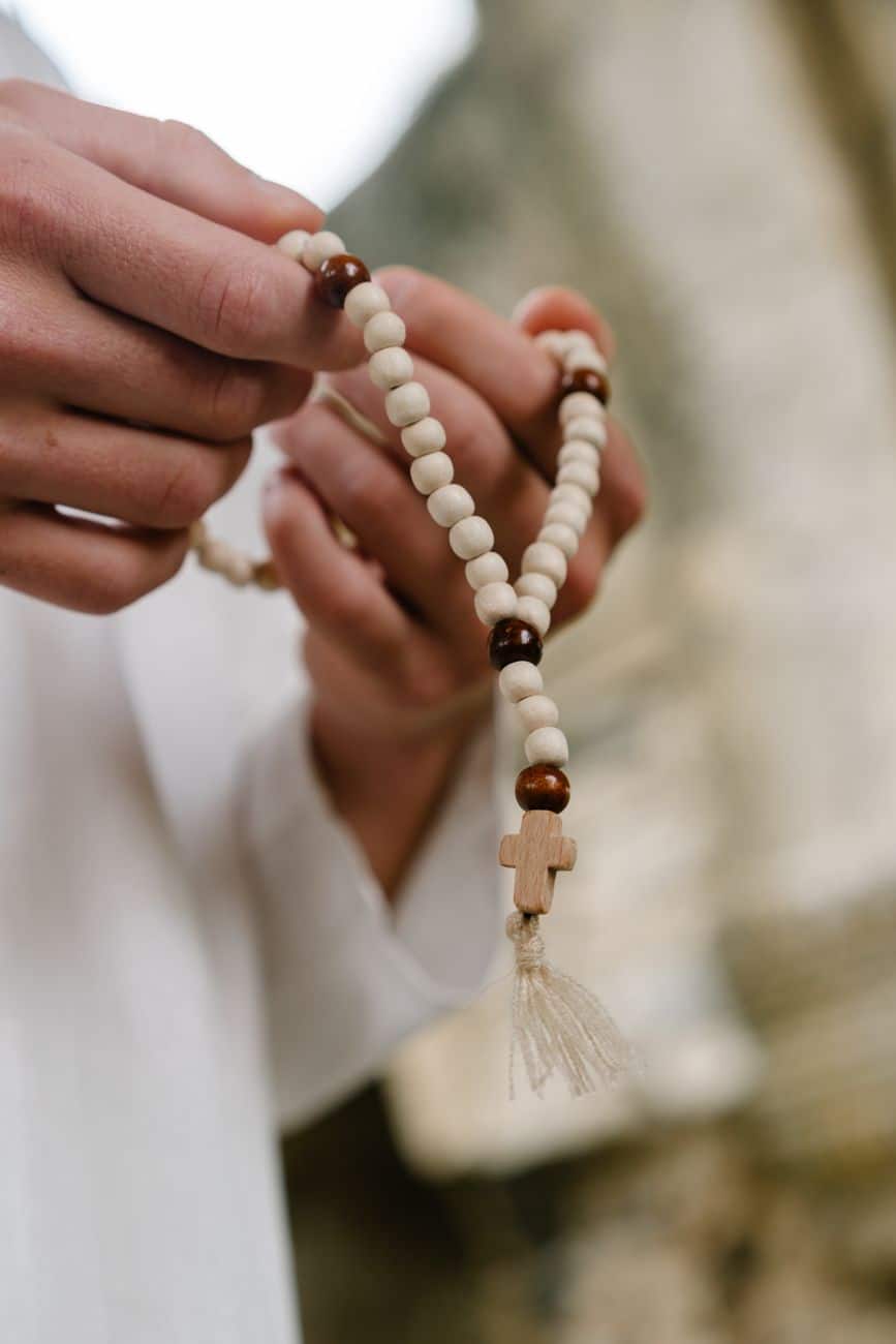 a person holding a rosary